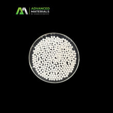 White microbeads or powder granules in a clear round petri dish, shown against a solid black background with the Advanced Materials by Vivara Scientific logo in the top-left corner.